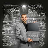 Idea Concept businessman with open laptop in his hands