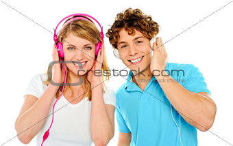 Couple enjoying music through headphones