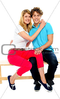 Young couple hugging on bench