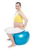 Pregnant woman exercises with gymnastic ball