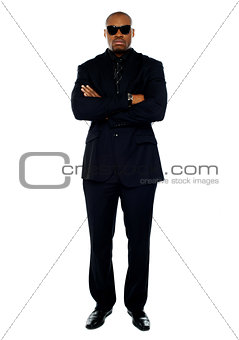 African corporate man standing with crossed arms
