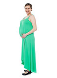Pregnant woman posing in trendy fashion wear