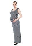 Cheerful pregnant lady in fashionable attire