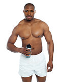 Athlete posing with health drink bottle