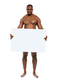 Naked man hiding behind blank white billboard
