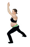 Healthy pregnant woman doing gymnastics