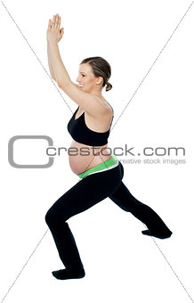Healthy pregnant woman doing gymnastics