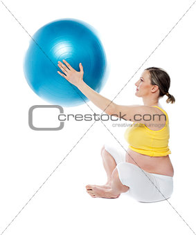 Attractive pregnant lady practicing yoga