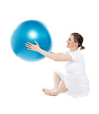 Pregnant woman sitting with exercise ball
