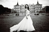 Caucasian young bride next to castle in west Ukraine