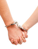 Couple's hands linked with handcuffs