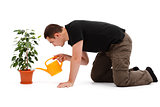Young man watering flower