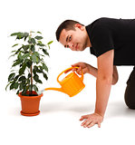 Young man watering flower