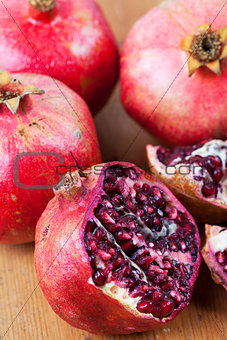 Freshly cut open pomegranate on wooden surface