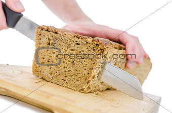 Cutting a homemade bread on a wooden board