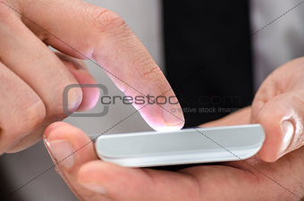 Detail of a man using a touchscreen phone