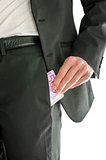 Front view of businessman putting money in his pocket