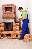 Mason building a masonry heater
