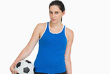 Serious sportswoman with a soccer ball
