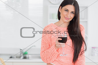 Smiling woman holding glass of wine