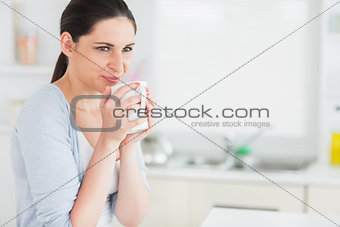 Thoughtful woman holding a mug