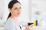 Smiling woman holding glass of red wine
