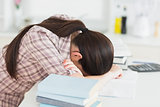 Sleepy woman leaning her head on the table