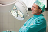 Happy surgeon sitting in an operating room