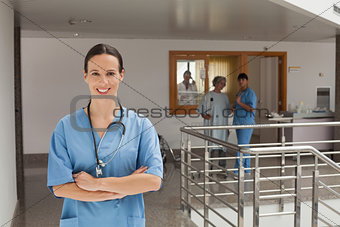 Smiling doctor standing in the hallway