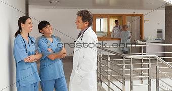 Doctor and two nurses discoursing in a hospital