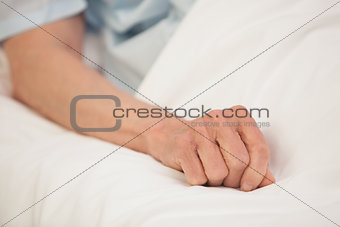 Elderly arm in hospital bed