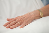 Hand of old woman with golden jewellery