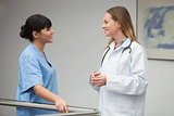 Nurse talking and smiling with female doctor