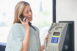 Female patient using payphone
