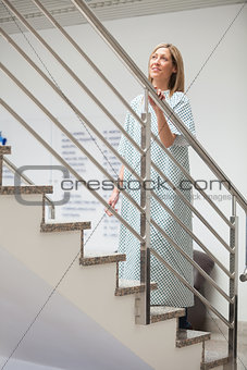 Female patient walking up stairs
