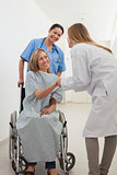Smiling female patient shaking hand of doctor