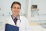 Smiling doctor holding a folder in bedroom