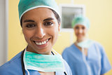 Woman wearing scrubs smiling in hospital room