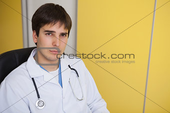 Doctor sits in yellow office