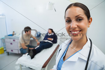 Doctor smiling in hospital room with patient