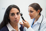 Patients ear being checked by doctor
