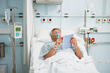 Patient lying in bed wearing oxygen mask