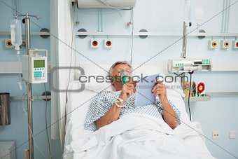 Patient lying in bed wearing oxygen mask