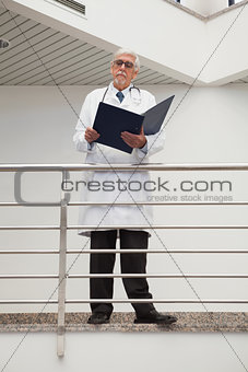 Doctor standing on the railing watching