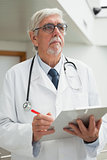 Doctor holding patient file and looking up