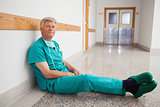 Doctor sitting on the floor smiling