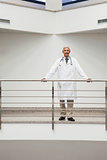 Doctor standing at the railing smiling