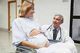 Doctor is talking to a pregnant woman