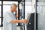 Man with IV drip using pay phone