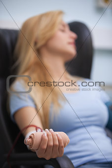 Woman relaxing while donating blood